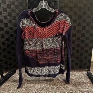 Small orange, white, and blue sweater